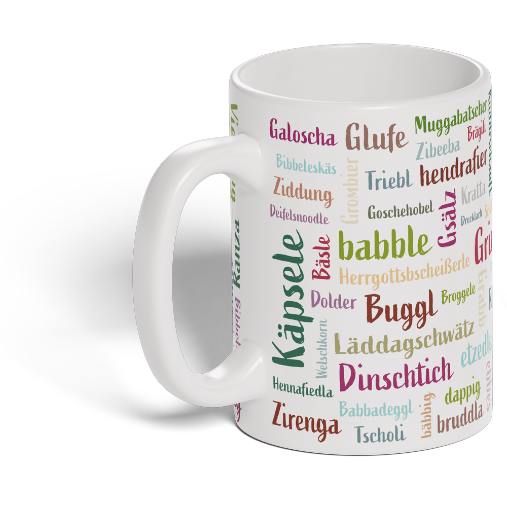 Die Mundart-Tasse ist mit bunten schwäbischen Begriffen in verschiedenen Schriften und Größen verziert – perfekt für Fans regionaler Sprache.