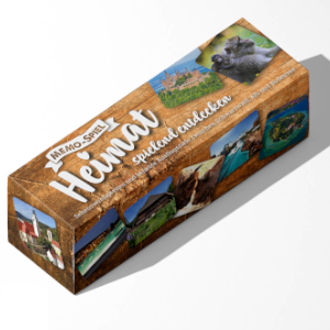 Rechteckige Box mit der Aufschrift Memo-Spiel „Heimat spielend entdecken“ mit Natur- und Tierfotos aus Schwarzwald und Bodensee auf holzgemustertem Hintergrund.
